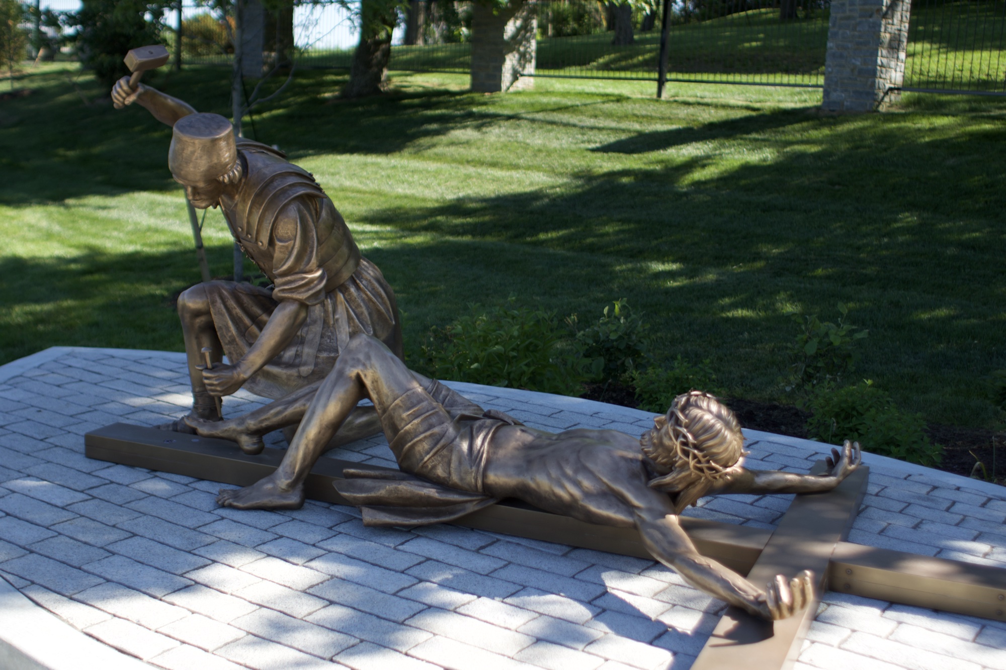 Bronze sculpture of Jesus nailed to the cross — Station XI of the Stations of the Cross at the Gardens at St. Patrick’s.