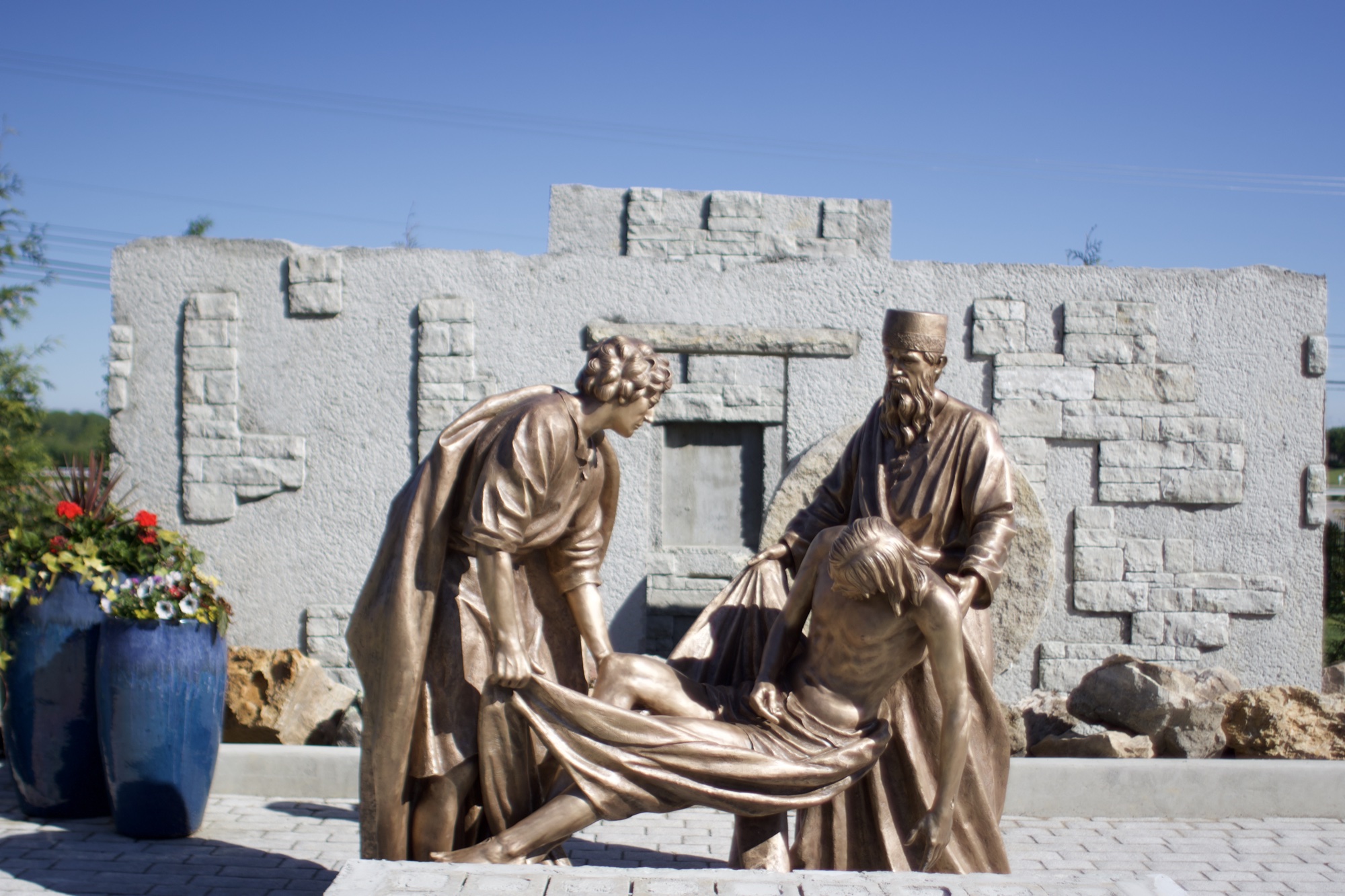 Bronze sculpture of Jesus being laid in the tomb — Station XIV of the Stations of the Cross at the Gardens at St. Patrick’s.