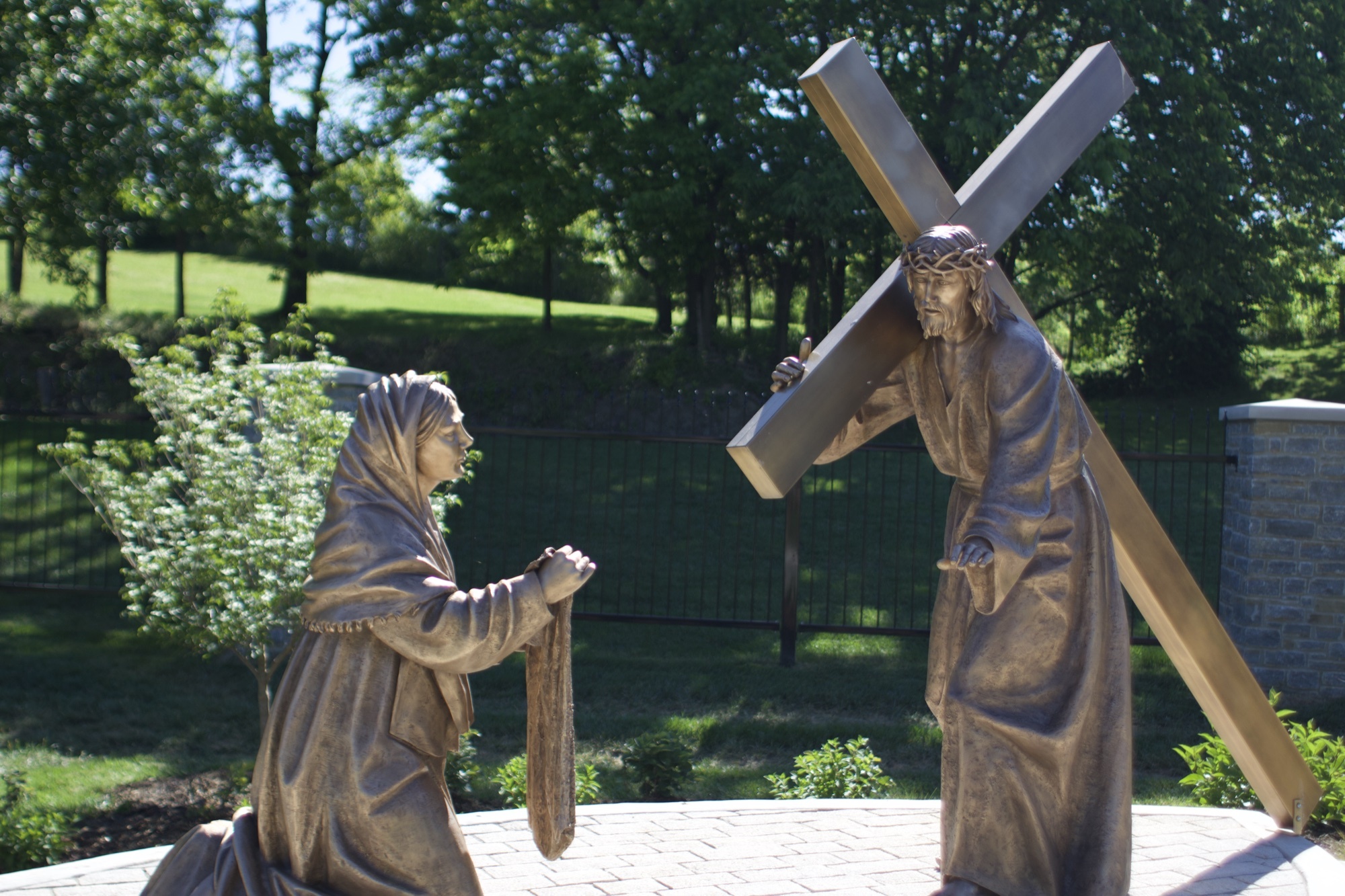 Bronze sculpture of Veronica wiping the face of Jesus — Station VI of the Stations of the Cross at the Gardens at St. Patrick’s.